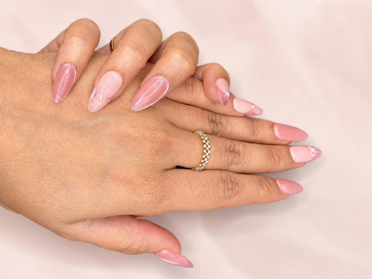 Blush Ribbon pink press-on nails worn on hands