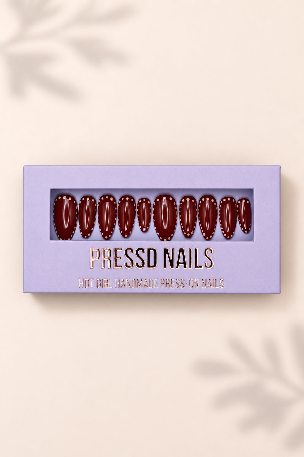 Burgundy Dots nail set in its lavender Pressd Nails box