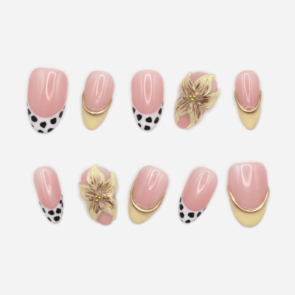 Cow Print and Lilies ten-nail set with pink beds, cow-print French tips and lily accents