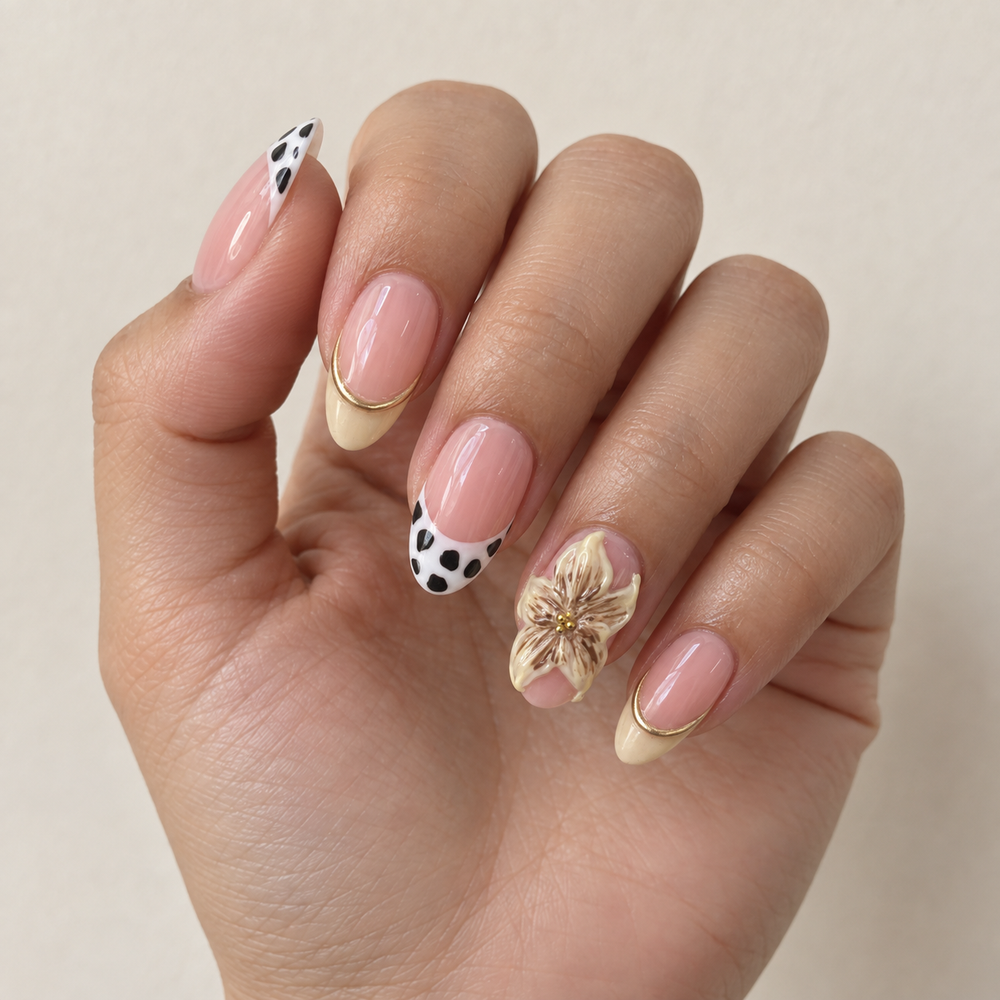 Cow Print and Lilies hand styling image with cow-print and cream French tips and a lily accent