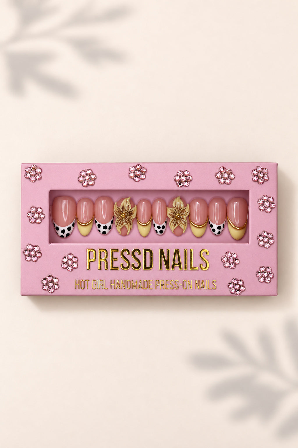 Cow Print and Lilies nail set in its pink Pressd Nails box